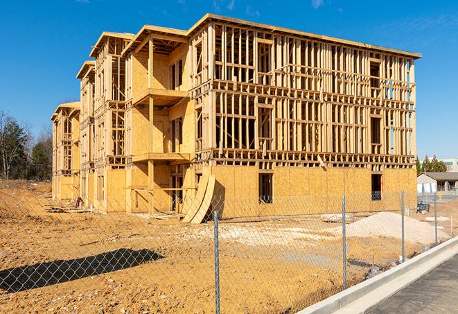 a close-up of temporary chain link fences enclosing a job site, signaling progress in the project's development in Belton, MO